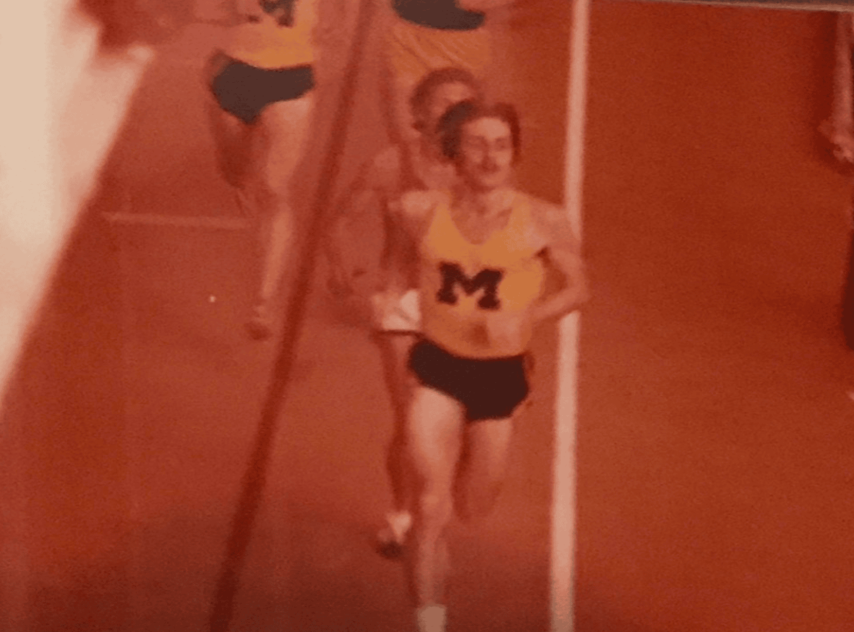 Athlete in motion on red track
